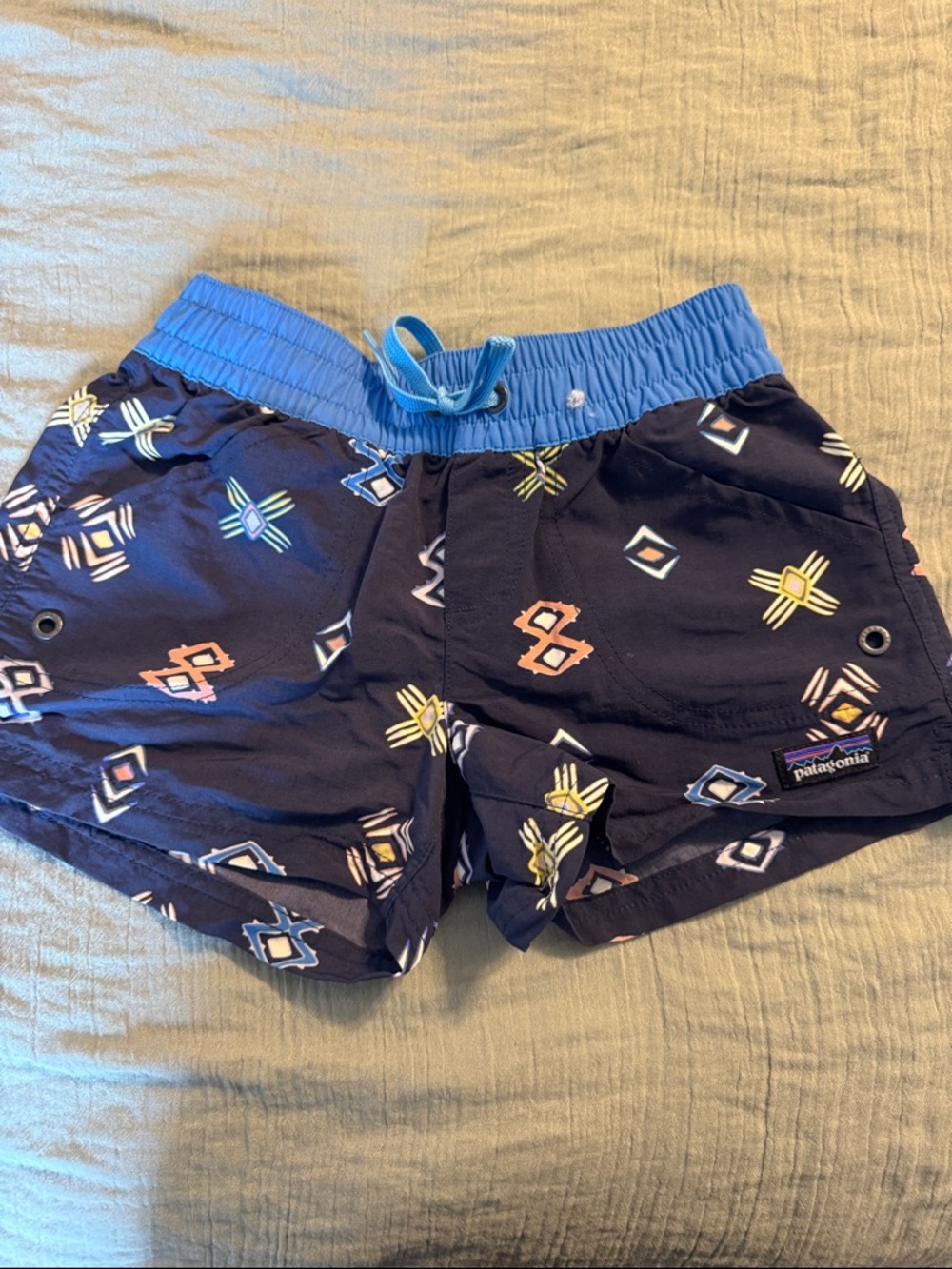Patagonia navy swim trunks with multicolor geometric print
